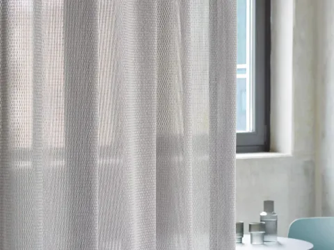 Création Baumann acoustic curtain in a bright interior.